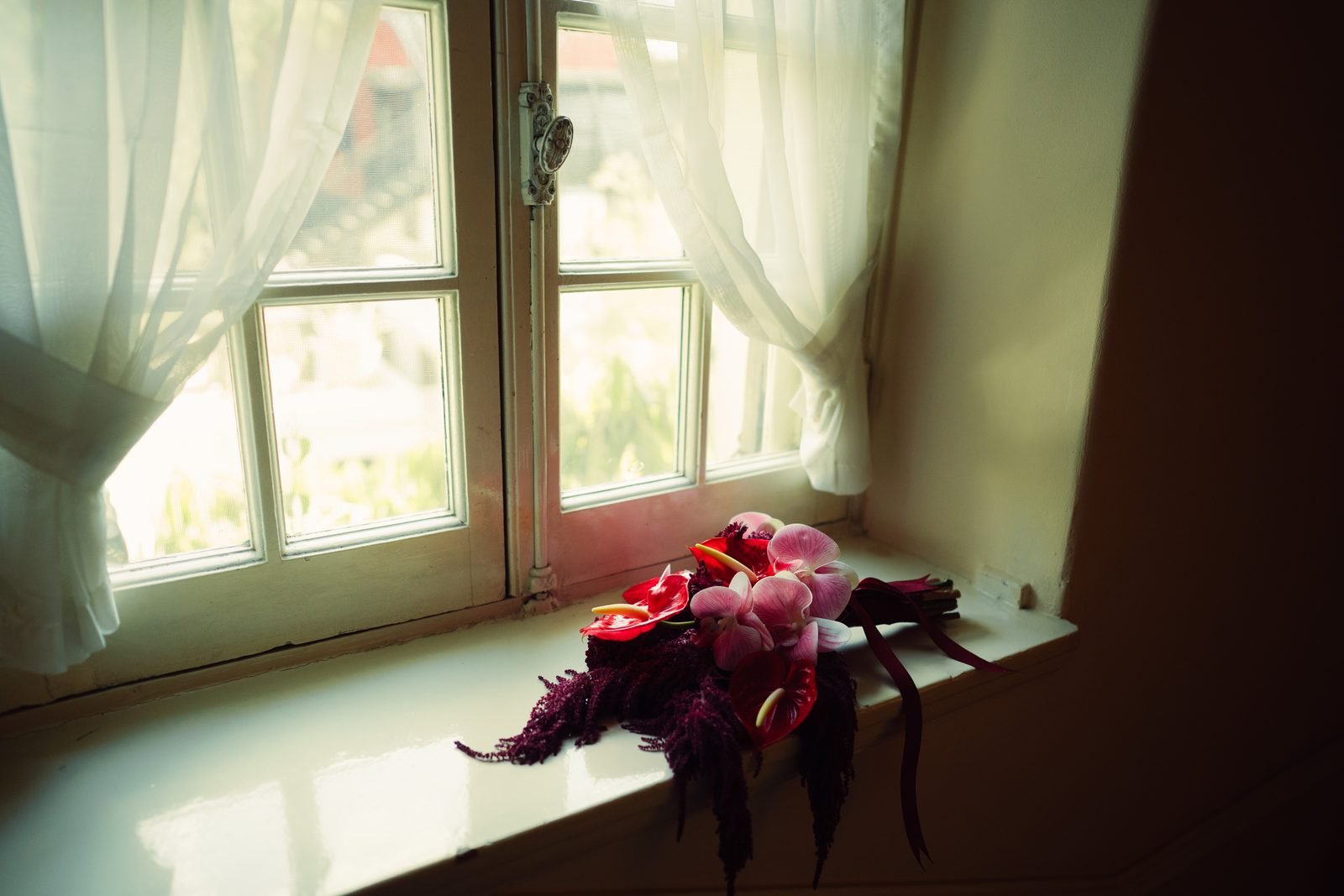 Bouquet resting on a window sill in soft light