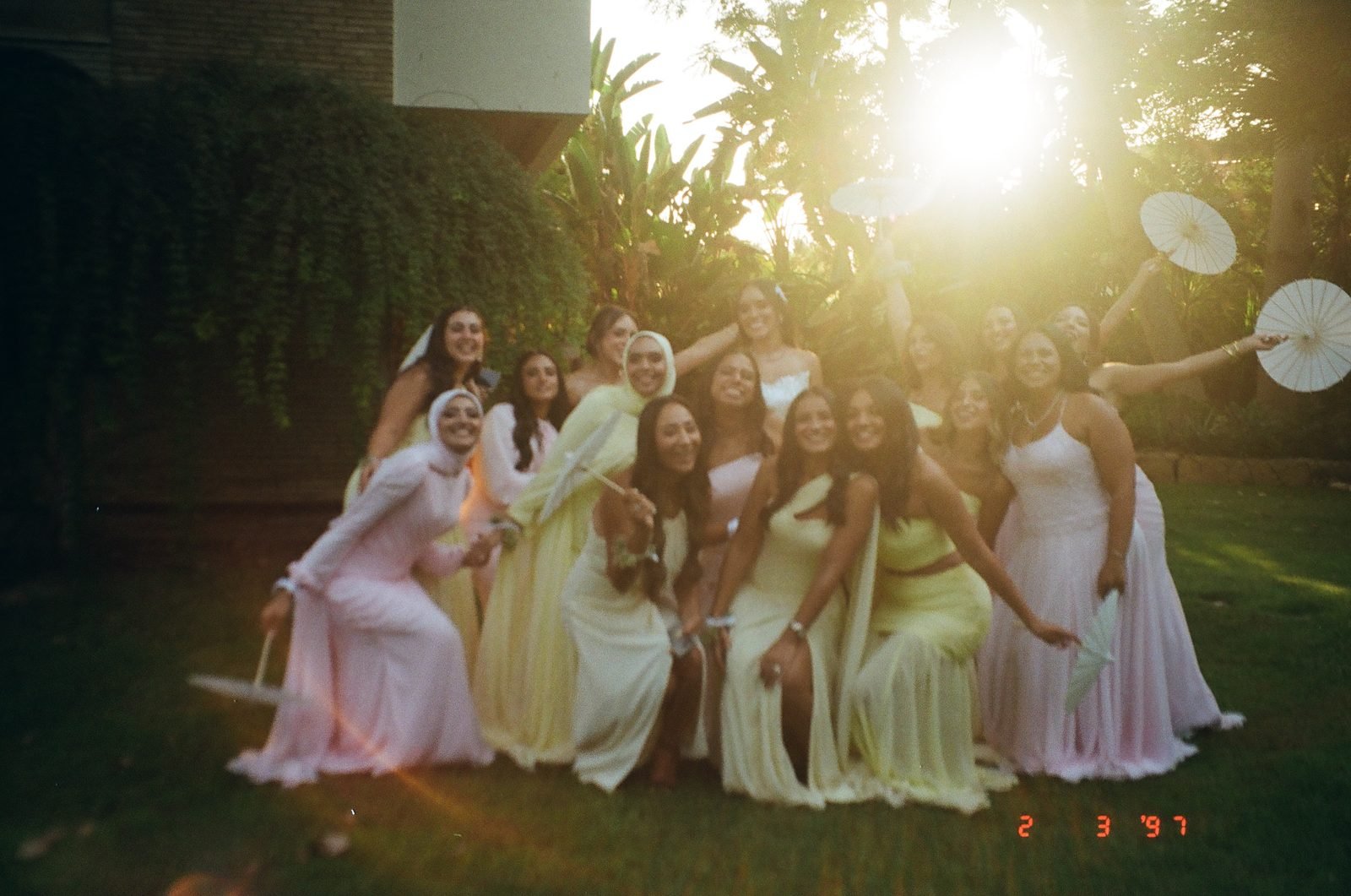 Bridesmaids laughing together in golden sunlight