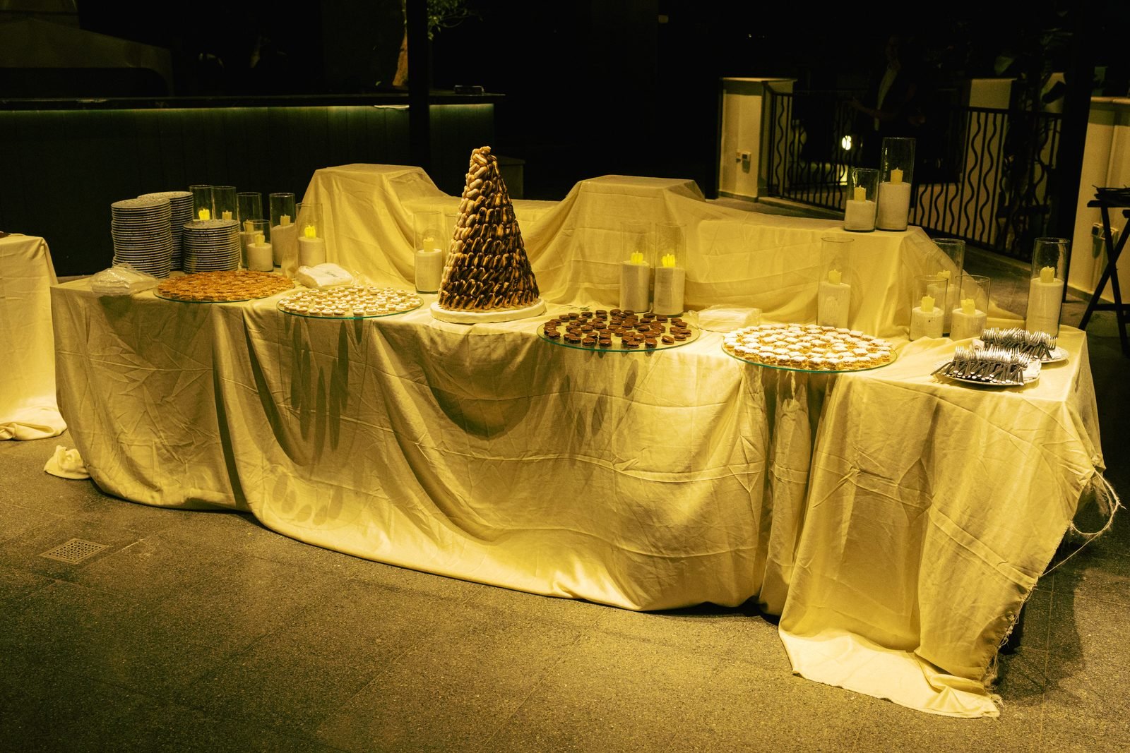 Dessert table covered in a gold cloth