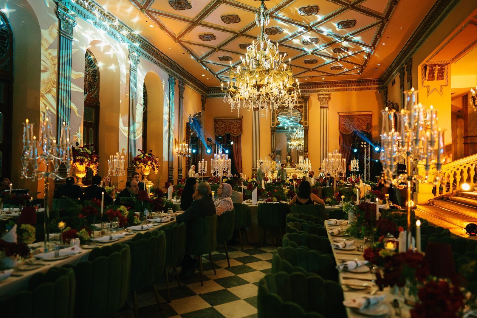 Reception hall with long tables and chandeliers