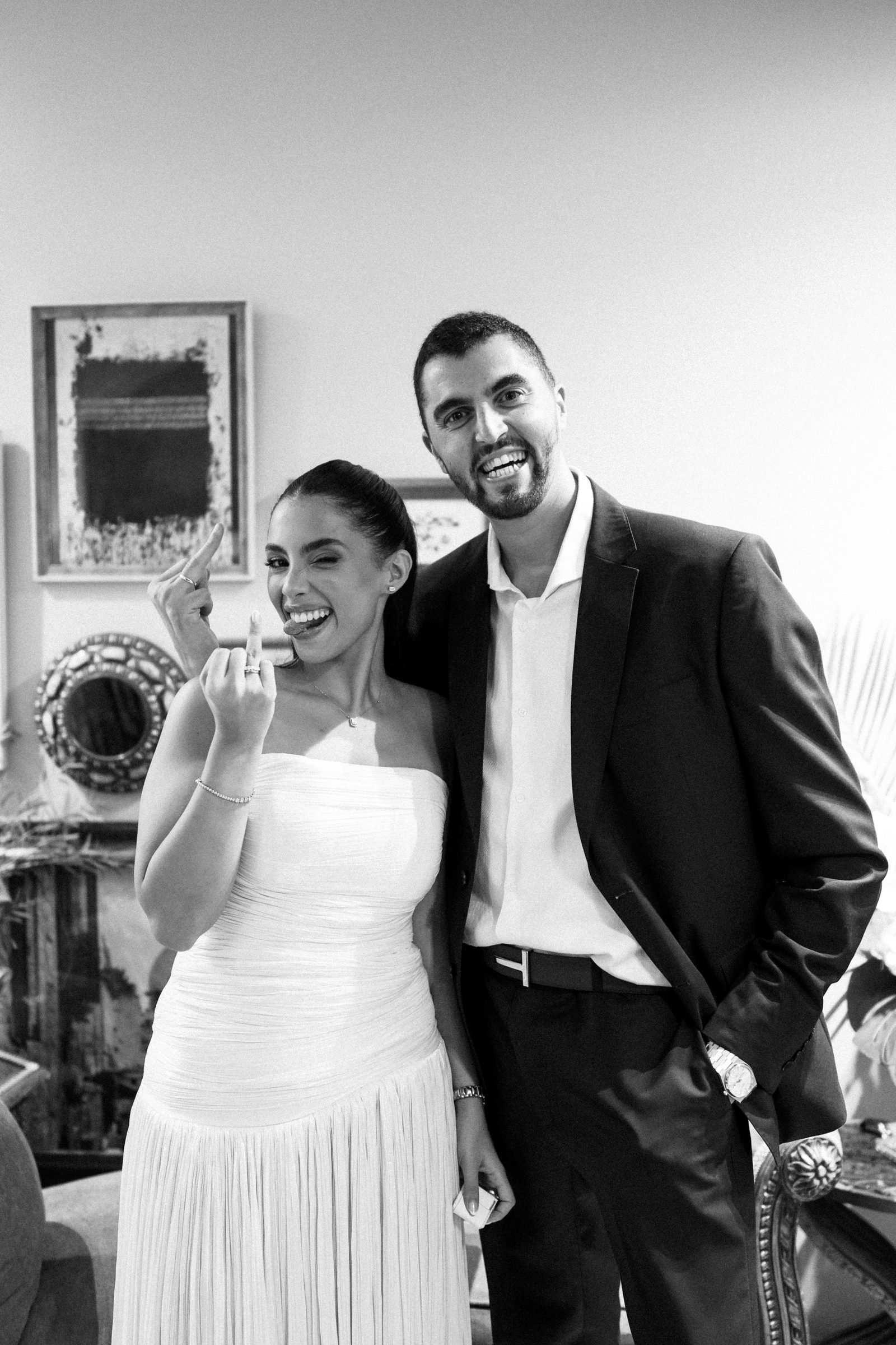 Couple smiling with a drink in hand, black and white