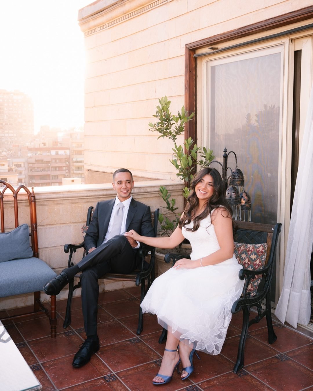 Couple seated on a balcony at golden hour