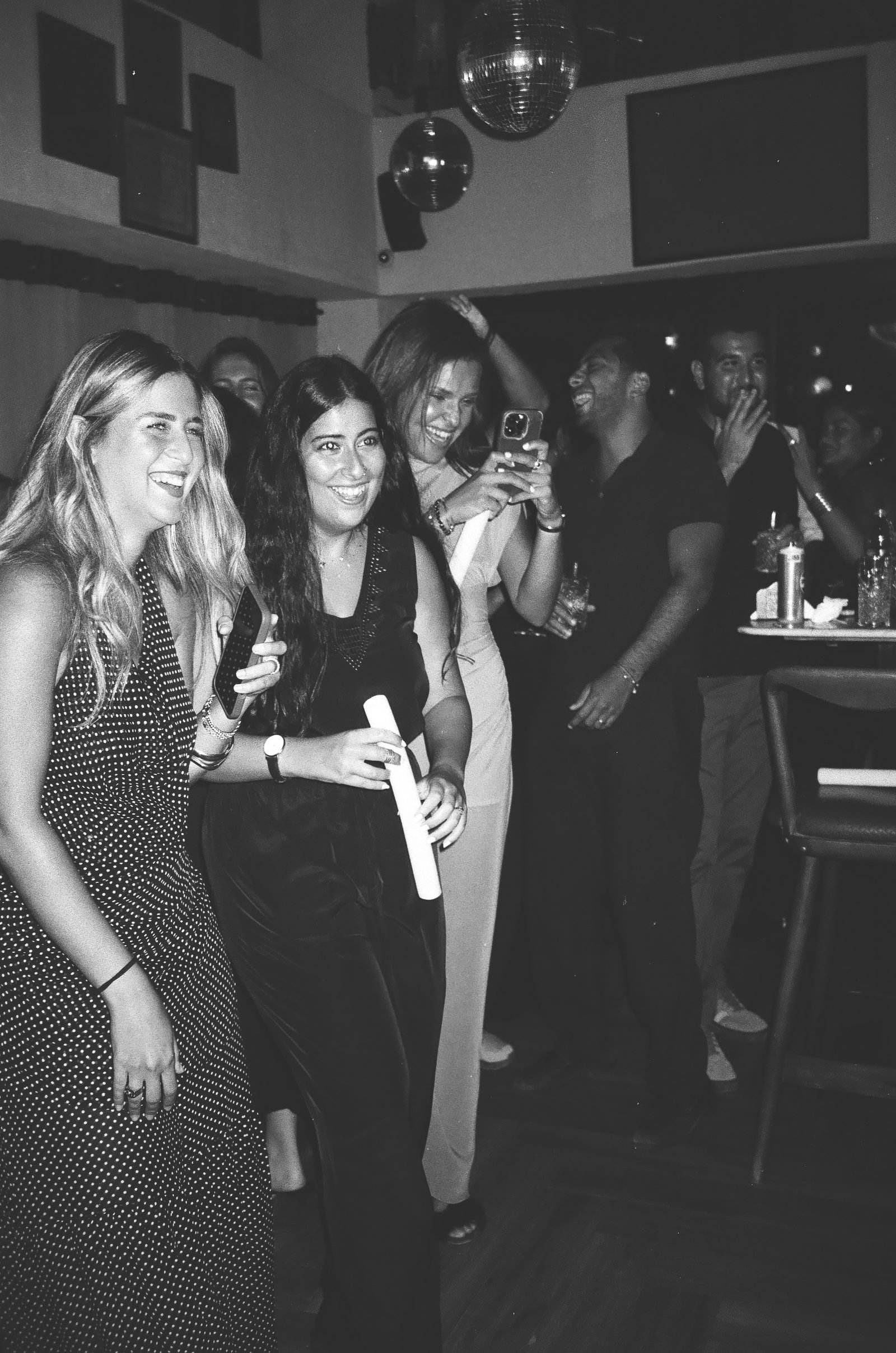Guests gathered together at the party, black and white