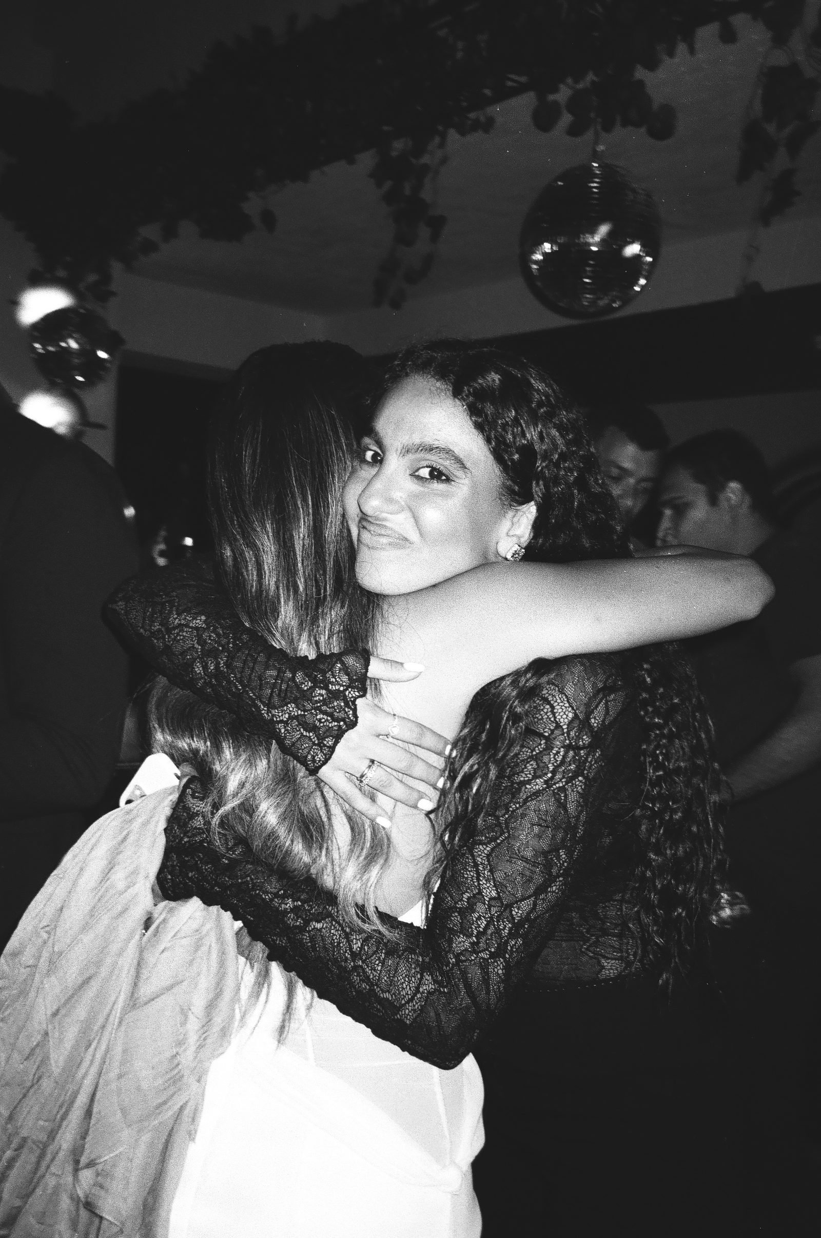 Two friends hugging, black and white