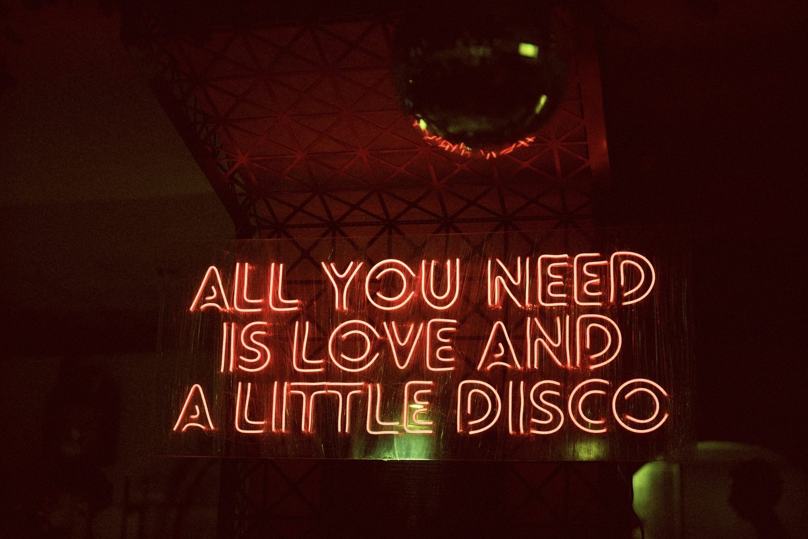 Neon sign glowing red in a dark room